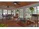 Bright sunroom with wood floors and ceiling, multiple windows, and comfortable seating at 9106 Dogwood Ridge Dr, Charlotte, NC 28227