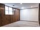 Finished basement space with classic wood paneling and a large window at 948 Kingswood Dr, Rock Hill, SC 29732