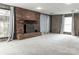 Bright finished basement showcasing a classic brick fireplace, and neutral carpet at 948 Kingswood Dr, Rock Hill, SC 29732