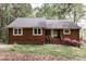 Charming, single-story house with a brown exterior, gray roof, and landscaped front yard at 948 Kingswood Dr, Rock Hill, SC 29732