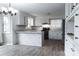 Updated kitchen featuring white cabinets, sleek appliances, wood flooring, and a stylish brick-accented breakfast bar at 948 Kingswood Dr, Rock Hill, SC 29732
