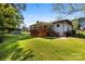 View of the home showcasing the backyard and covered deck at 1012 Woodlark Ct, Gastonia, NC 28056