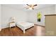 Bright bedroom with hardwood floors, ceiling fan, and a sunny window view at 1012 Woodlark Ct, Gastonia, NC 28056