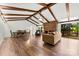 Open-concept living room boasts hardwood floors, fireplace, and exposed beams at 1012 Woodlark Ct, Gastonia, NC 28056