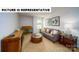 Inviting bonus room featuring a cozy gray sofa and rustic wood accents at 103 Way Cross Ln, Troutman, NC 28166