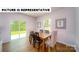 Elegant dining area featuring hardwood floors, ample natural light, and seamless access to the outdoors at 103 Way Cross Ln, Troutman, NC 28166