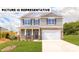 Charming two-story home featuring a stone-accented facade, a two-car garage, and a well-maintained lawn at 103 Way Cross Ln, Troutman, NC 28166