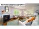 Bright and airy living room with hardwood floors, a fireplace, and an open connection to the kitchen at 103 Way Cross Ln, Troutman, NC 28166