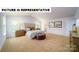 Airy main bedroom featuring carpeted floor, and neutral wall color, and an ensuite bathroom at 103 Way Cross Ln, Troutman, NC 28166