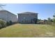 Expansive backyard featuring a well-maintained lawn, privacy fence, and covered patio area at 11616 Solstice Way, Huntersville, NC 28078