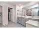 Modern bathroom featuring a double vanity, a large mirror, and a tiled floor at 11616 Solstice Way, Huntersville, NC 28078