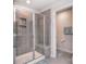 Elegant bathroom featuring a glass-enclosed shower with built-in bench and modern gray tiling at 11616 Solstice Way, Huntersville, NC 28078