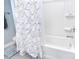 A clean, well-maintained bathroom with a white shower curtain and built-in shelving at 11616 Solstice Way, Huntersville, NC 28078