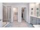 Bright bathroom featuring glass shower, double doors and vanity with storage at 11616 Solstice Way, Huntersville, NC 28078