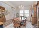 Dining room with wood table, chandelier, and large windows offering natural light at 11616 Solstice Way, Huntersville, NC 28078