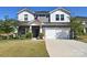 Charming two-story home with stone accents, a welcoming porch, and attached two-car garage at 11616 Solstice Way, Huntersville, NC 28078