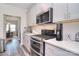 Modern kitchen featuring stainless steel appliances, white countertops, and ample cabinet space at 11616 Solstice Way, Huntersville, NC 28078
