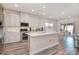 Bright, open kitchen featuring white cabinets, quartz countertops, and stainless steel appliances at 11616 Solstice Way, Huntersville, NC 28078