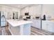 Beautiful kitchen with white cabinets, a large island with quartz countertops, and stainless steel appliances at 11616 Solstice Way, Huntersville, NC 28078