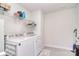 Functional laundry room with modern appliances, storage shelves, and tiled flooring at 11616 Solstice Way, Huntersville, NC 28078