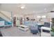 Open-concept living room with staircase, kitchen, and ample seating at 11616 Solstice Way, Huntersville, NC 28078