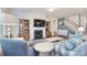 Bright living room with a fireplace, blue accent wall, and staircase access at 11616 Solstice Way, Huntersville, NC 28078
