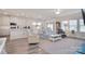 Open-concept living room flowing into a kitchen with white cabinets and ample natural light at 11616 Solstice Way, Huntersville, NC 28078