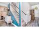 Carpeted staircase with white railing and blue accent wall and decorative hall tree at 11616 Solstice Way, Huntersville, NC 28078