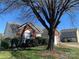Charming brick and vinyl home with lush landscaping and mature trees in a well-maintained neighborhood at 12031 Brownestone View Dr, Charlotte, NC 28269