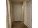 Hallway view of a home featuring neutral walls, carpet floors, and white doors at 12031 Brownestone View Dr, Charlotte, NC 28269