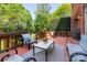 Relaxing deck area featuring outdoor seating and a grill, ideal for enjoying the backyard views at 12122 Camden Trail Ct, Charlotte, NC 28277