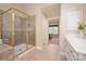 Bathroom featuring a tiled shower with glass enclosure and a neutral-toned vanity at 12122 Camden Trail Ct, Charlotte, NC 28277
