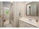 Bright bathroom featuring a white vanity, decorative mirror, and a shower-tub combination at 12122 Camden Trail Ct, Charlotte, NC 28277