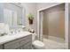 Bathroom features a marble countertop vanity, tiled bathtub, and decorative accents at 12122 Camden Trail Ct, Charlotte, NC 28277
