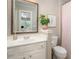 Well-lit bathroom with a white vanity, framed mirror, and a separate toilet and shower area at 12122 Camden Trail Ct, Charlotte, NC 28277