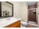 Modern bathroom with a wood vanity, a vessel sink, a black mirror, and a glass-enclosed shower at 12122 Camden Trail Ct, Charlotte, NC 28277