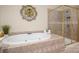 Close up of the soaking tub with tile surround and a glass enclosed shower at 12122 Camden Trail Ct, Charlotte, NC 28277