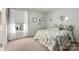 Bedroom with carpet, a queen size bed with a floral comforter, and a bright window at 12122 Camden Trail Ct, Charlotte, NC 28277