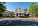 Stately two-story home with a charming front porch and well-manicured landscaping, exuding curb appeal at 12122 Camden Trail Ct, Charlotte, NC 28277
