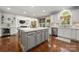 Kitchen features stainless appliances, white cabinets and large island with seating at 12122 Camden Trail Ct, Charlotte, NC 28277