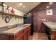 Basement kitchenette with a sink, refrigerator, and bar area perfect for entertaining at 12122 Camden Trail Ct, Charlotte, NC 28277