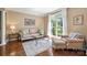 Cozy living room featuring hardwood floors, natural light, and neutral decor at 12122 Camden Trail Ct, Charlotte, NC 28277