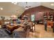 Open-concept living area with a brick wall, hardwood floors, and multiple seating areas at 12122 Camden Trail Ct, Charlotte, NC 28277