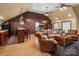 Spacious living room with hardwood floors, a brick accent wall, and comfortable seating at 12122 Camden Trail Ct, Charlotte, NC 28277