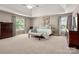 Spacious main bedroom featuring trey ceilings, neutral carpet, and large windows with natural light at 12122 Camden Trail Ct, Charlotte, NC 28277