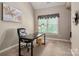 Office space with a black desk, leather chair, and natural light from a window at 12122 Camden Trail Ct, Charlotte, NC 28277