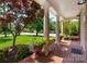 Charming front porch with brick flooring, stately columns, and manicured landscaping at 12122 Camden Trail Ct, Charlotte, NC 28277