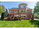 Beautiful brick home with a unique turret design, surrounded by a well-maintained lawn and landscaping at 12122 Camden Trail Ct, Charlotte, NC 28277
