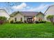 Beautiful backyard featuring green grass, a patio table with chairs and beautiful landscaping at 13505 Michael Lynn Rd, Charlotte, NC 28278