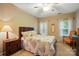 Well-lit bedroom with a ceiling fan, two windows and carpeted floors at 13505 Michael Lynn Rd, Charlotte, NC 28278